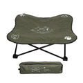 Green pet camping bed with black legs and a matching carrying bag on a white background